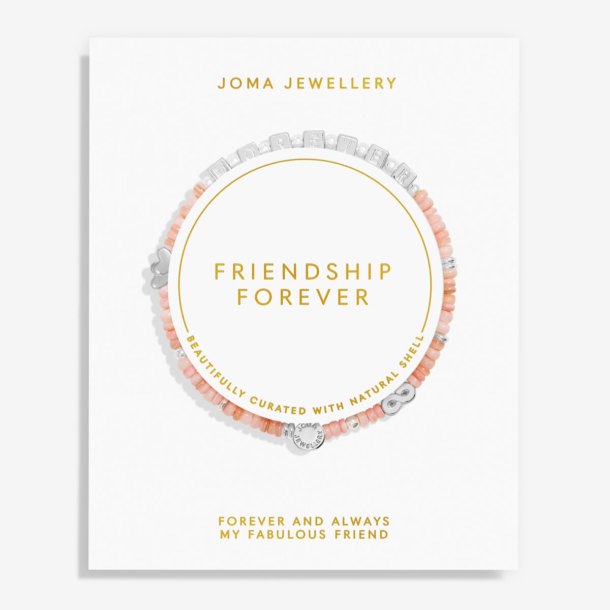 A Joma Jewellery 'Friendship Forever' bracelet displayed on its white presentation card. The bracelet features peach-pink beads, silver-toned shell charms, and a silver heart-shaped charm, arranged in a circle on the card with gold text.