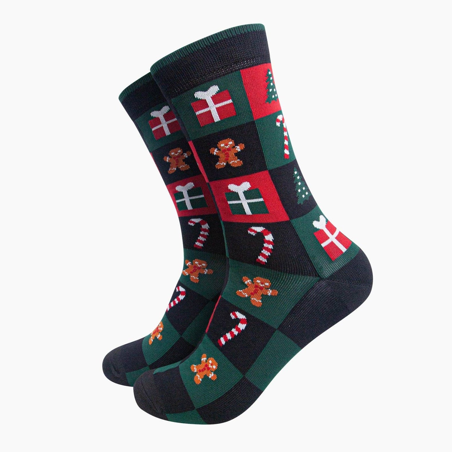 A pair of crew socks with a festive Christmas checkerboard pattern featuring red, dark green, black, white, and gingerbread men motifs, shown on a plain light gray background.